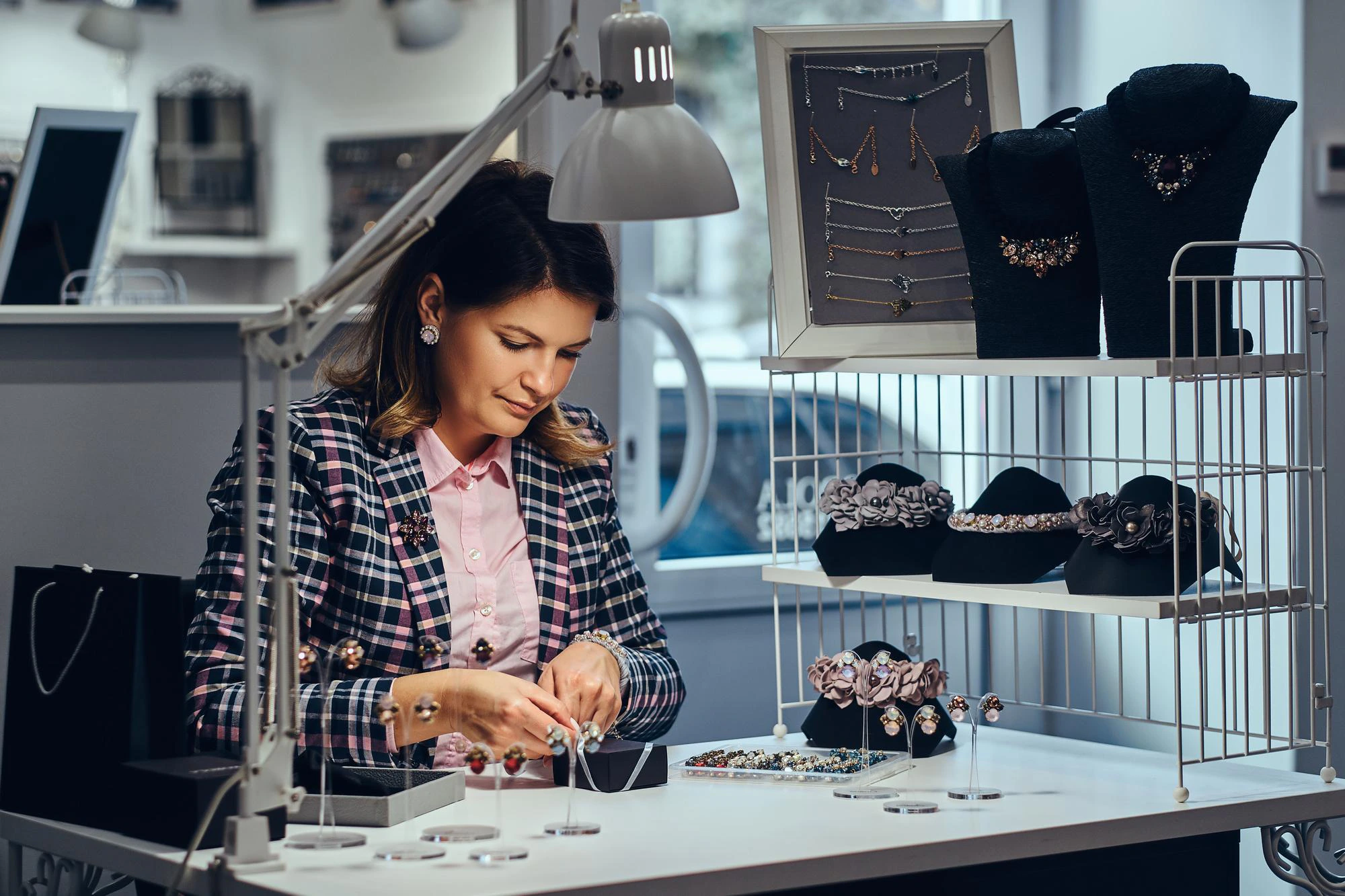 portrait-elegantly-dressed-woman-seller-packs-precious-earrings-box-her-client-luxury-jewelry-store_613910-21258